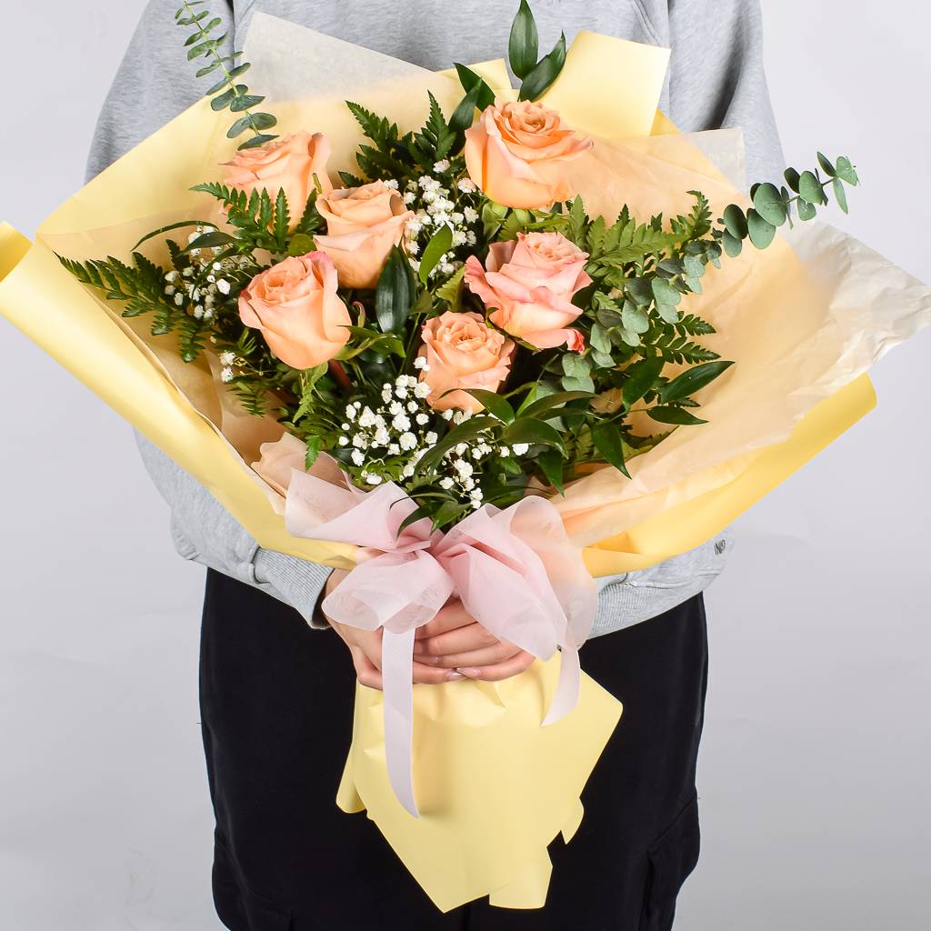 6 Fresh Peach Coloured Roses With Greenery Wrapped In Luxury Paper