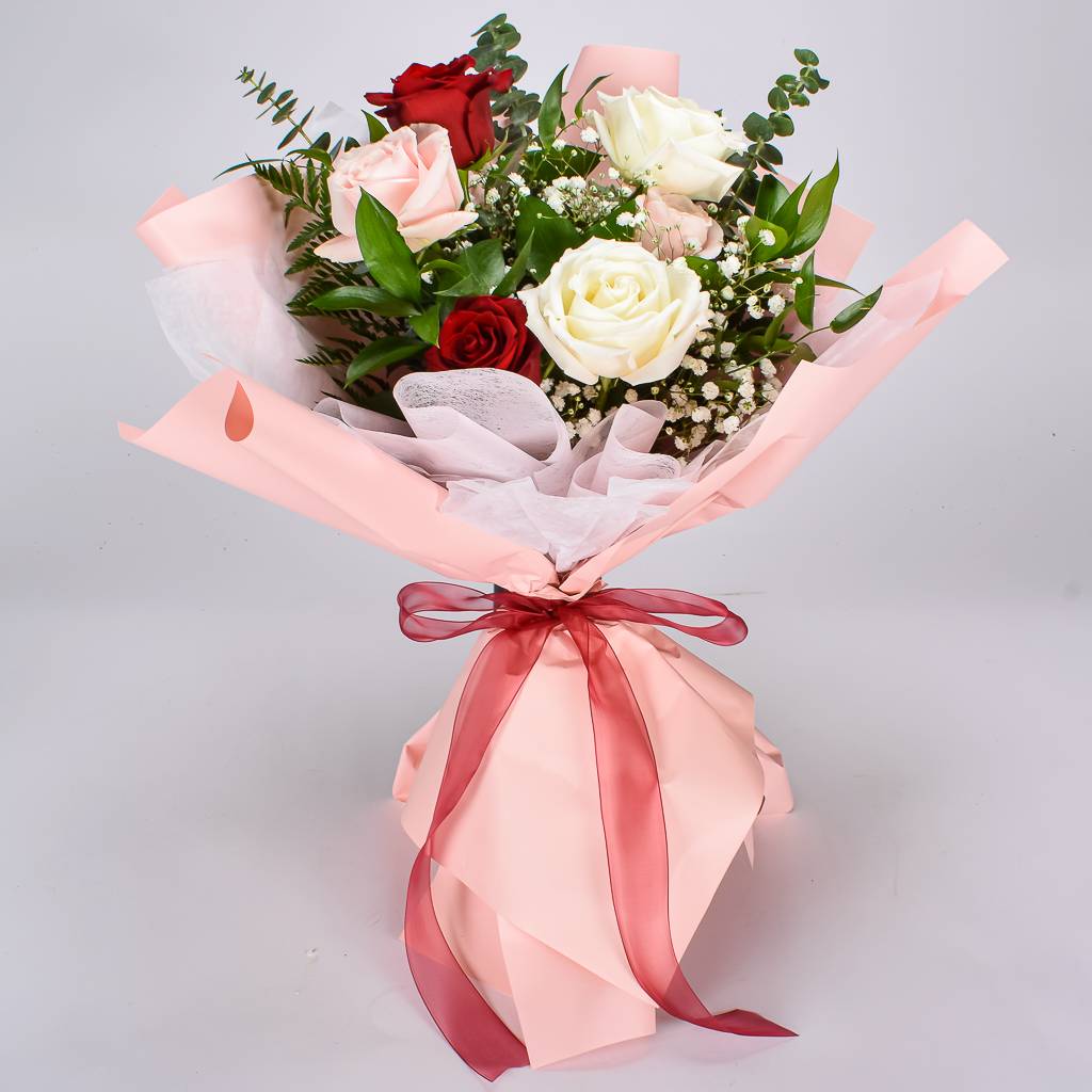 Six Pink, White, And Red Roses Wrapped In Pink Korean Paper and Tied With a Bow